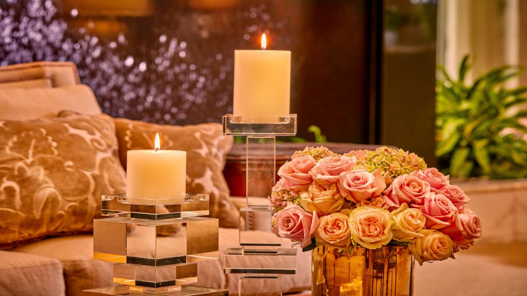 A cozy waiting area with candles and flowers at Sparkman/Hillcrest Funeral Home